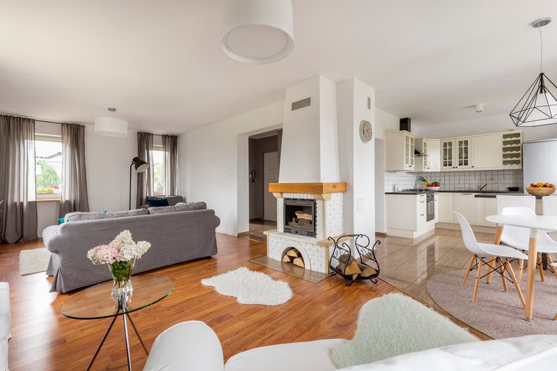Sala amplia con chimenea, en colores blancos y grises